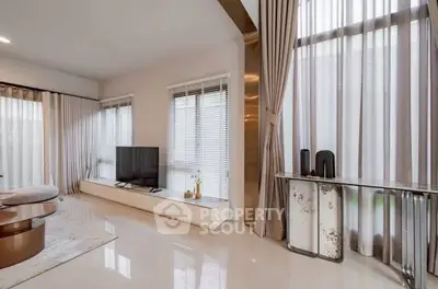 Spacious modern living room with large windows and elegant decor