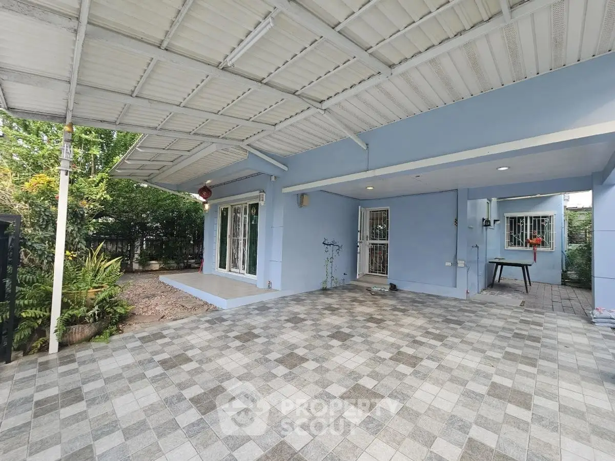 Spacious covered patio with tiled flooring and garden view in modern home