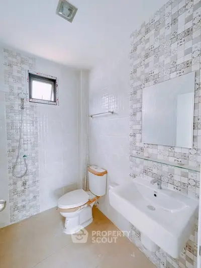 Modern bathroom with sleek white tiles and contemporary fixtures