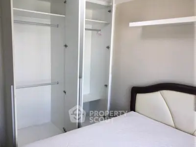 Spacious bedroom with built-in wardrobe and modern bed frame, perfect for stylish living.