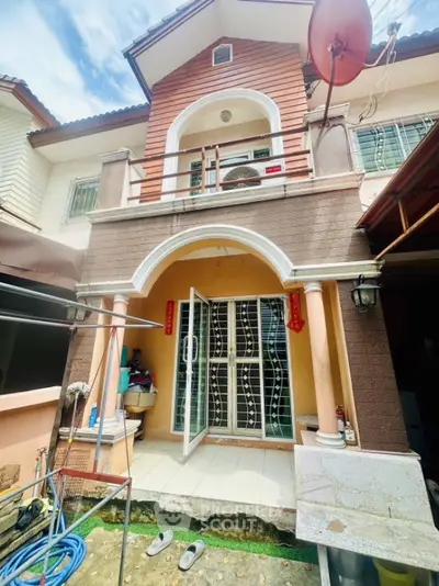 Charming two-story house with unique architectural design and inviting entrance