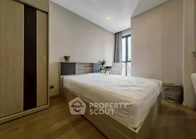 Spacious modern bedroom with natural light and wooden flooring