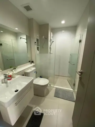 Modern bathroom with glass shower and sleek fixtures