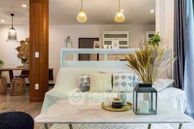 Charming living room with cozy decor and modern lighting in a stylish home.