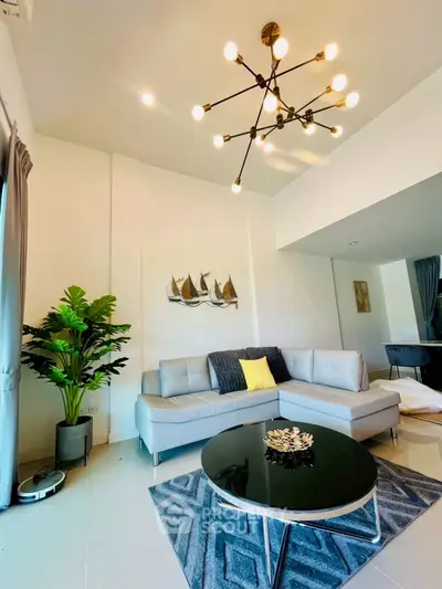 Stylish modern living room with elegant chandelier and cozy sectional sofa