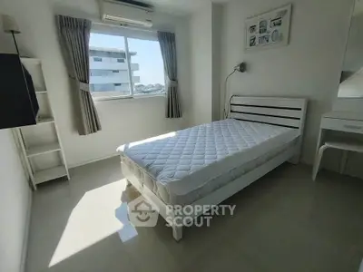 Bright bedroom with modern white furniture and large window view