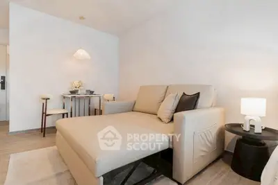 Modern living room with beige sofa and stylish dining area, perfect for cozy gatherings.