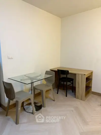 Cozy study nook with modern desk and glass table in minimalist apartment