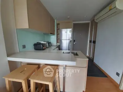 Modern kitchen with sleek appliances and breakfast bar seating