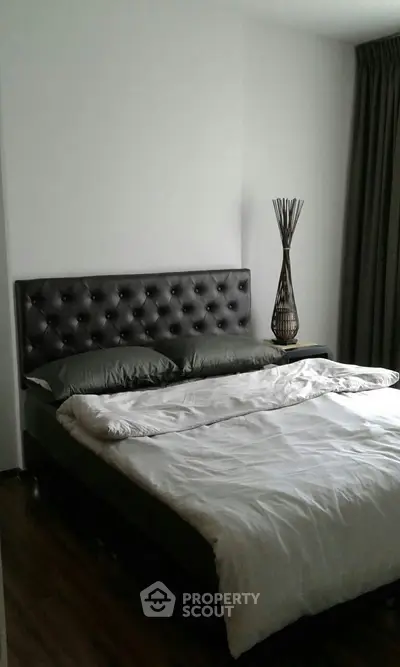 Elegant bedroom with modern decor and plush bedding in a stylish apartment.