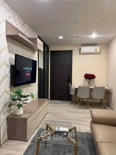 Modern living room with stylish decor and open dining area, featuring a wall-mounted TV and elegant furniture.