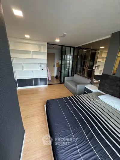 Modern bedroom with sleek design and spacious layout, featuring a comfortable bed and stylish furniture.