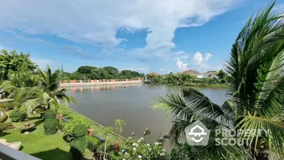 Stunning waterfront view with lush greenery and clear blue sky