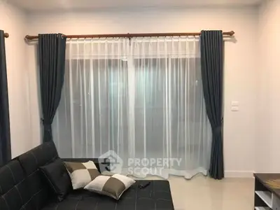 Cozy living room with elegant curtains and modern sofa