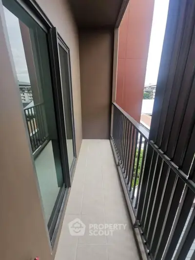 Modern apartment balcony with sleek railing and city view