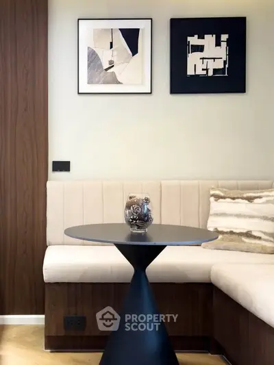 Stylish modern living room corner with elegant decor and art pieces.