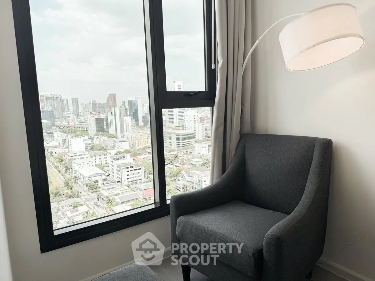 Modern apartment with stunning city view from cozy living room corner.