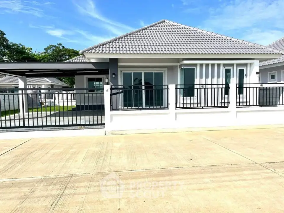 Charming single-story house with modern design and spacious driveway in a serene neighborhood.