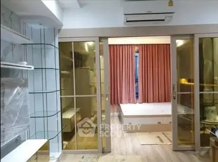 Modern apartment interior with sliding glass doors and air conditioning unit