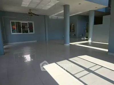 Spacious open-plan living area with abundant natural light and modern design.