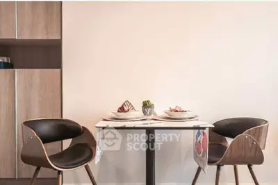 Stylish dining area with modern chairs and elegant table setting in a cozy apartment.