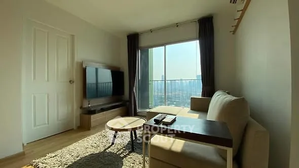 Bright living room with modern furniture and city view balcony.