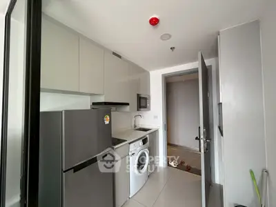 Modern compact kitchen with appliances including fridge, washing machine, and microwave in sleek design.