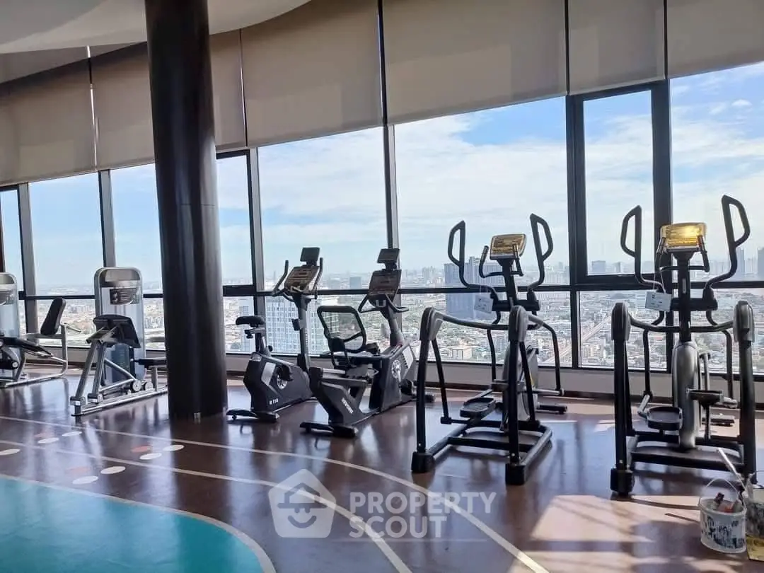 Luxurious high-rise gym with panoramic city views and modern fitness equipment.