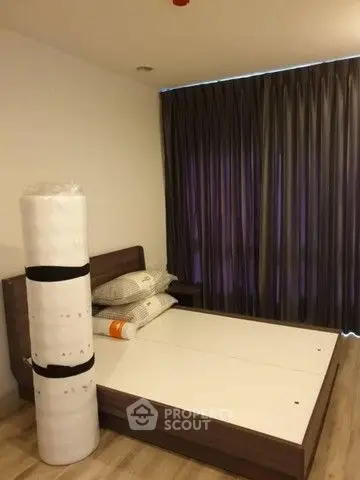 Cozy bedroom with modern bed frame and new mattress in a stylish apartment.