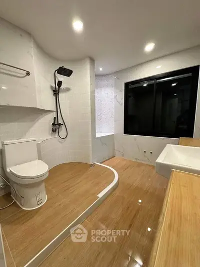 Modern bathroom with sleek fixtures and wooden flooring