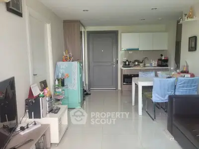Modern open-plan living room and kitchen with sleek design and natural light.