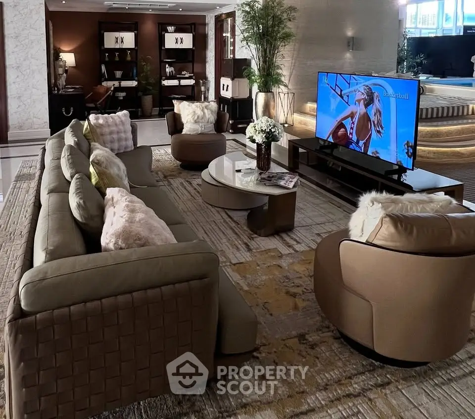 Luxurious living room with plush seating and large TV, perfect for relaxation and entertainment.
