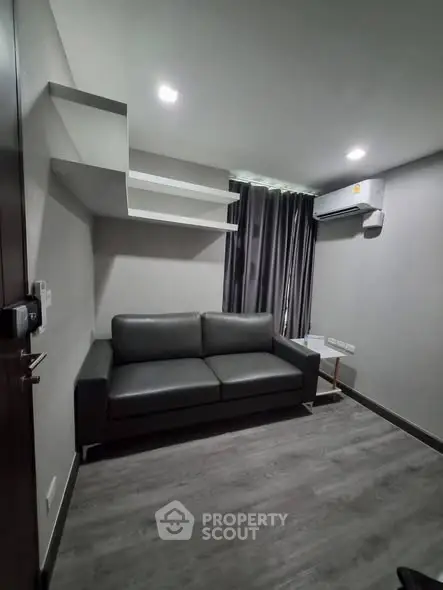 Modern living room with sleek sofa and air conditioning