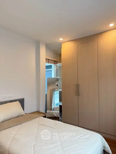 Cozy bedroom with modern wooden wardrobe and soft lighting