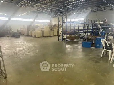 Spacious industrial warehouse with ample storage and shelving units