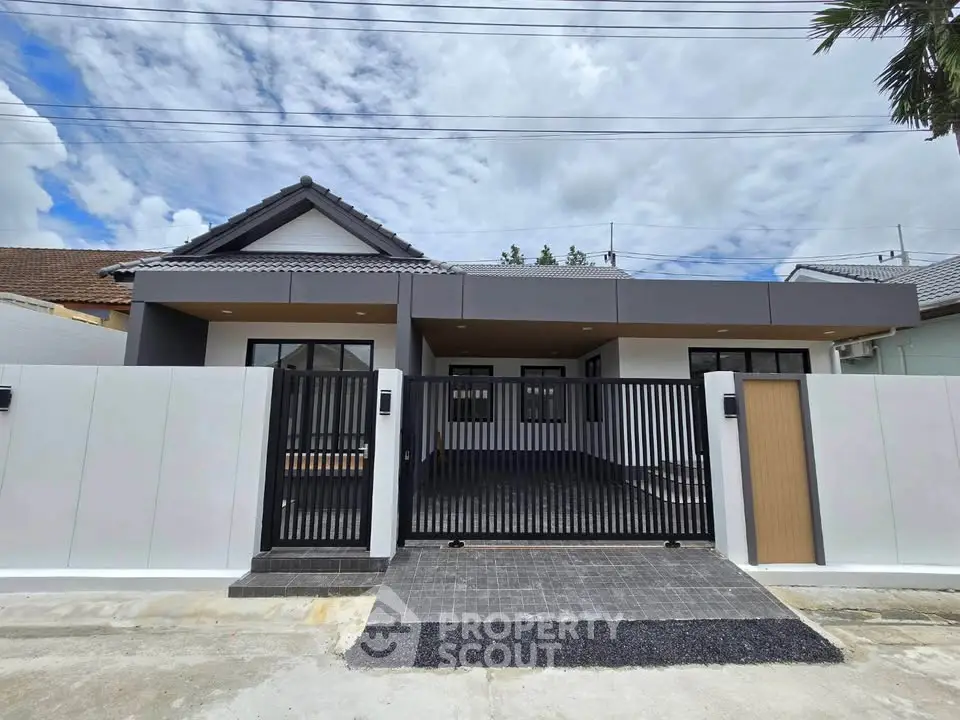 Modern single-story house with sleek design and gated entrance, perfect for contemporary living.