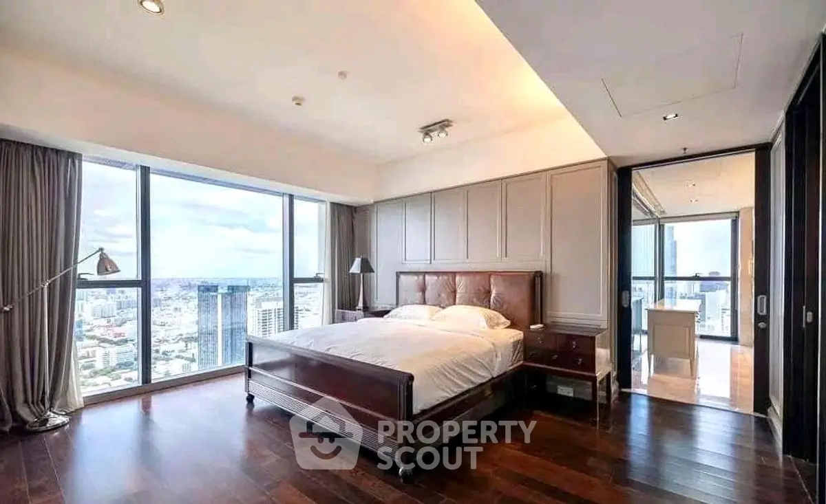 Luxurious bedroom with stunning city view and elegant wooden flooring.