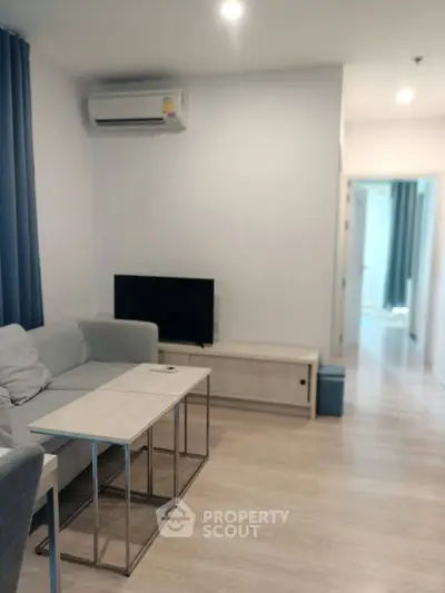 Modern living room with sleek furniture and air conditioning