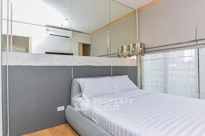 Modern bedroom with sleek design, featuring a comfortable bed and stylish decor, perfect for urban living.