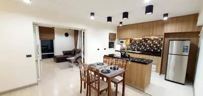 Modern open kitchen and living area with stylish decor and appliances