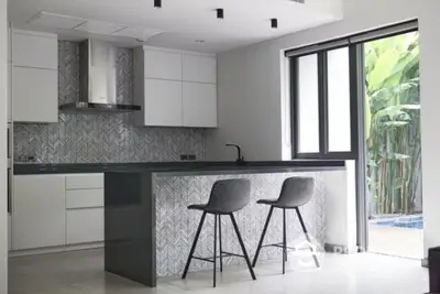 Modern kitchen with sleek design and breakfast bar seating