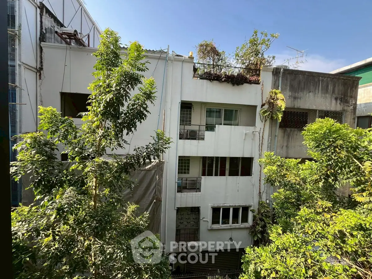 Charming urban building with lush greenery and modern facade