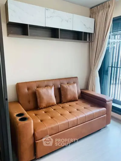Modern living room with stylish brown leather sofa and elegant wall-mounted storage