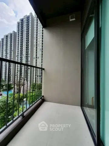Modern apartment balcony with city view and high-rise buildings
