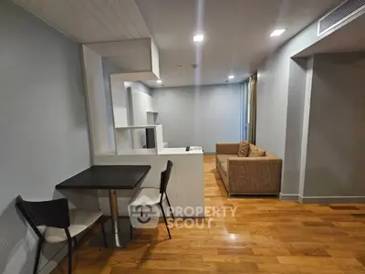 Modern living room with wooden flooring and cozy seating area