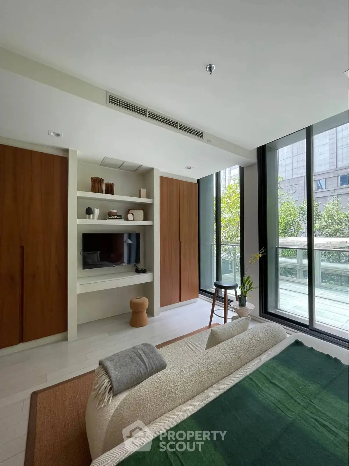 Modern living room with large windows and stylish decor in urban apartment