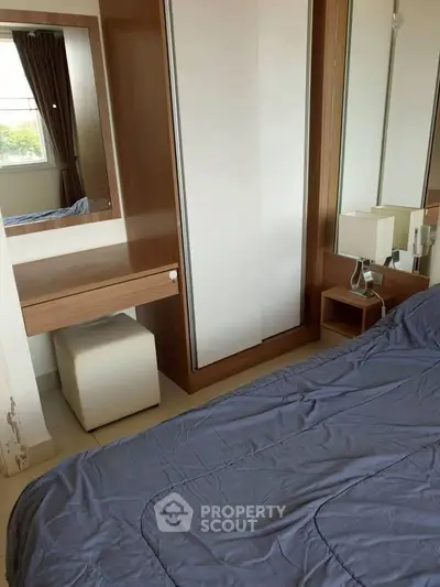 Cozy bedroom with modern furniture and natural light, perfect for relaxation and comfort.