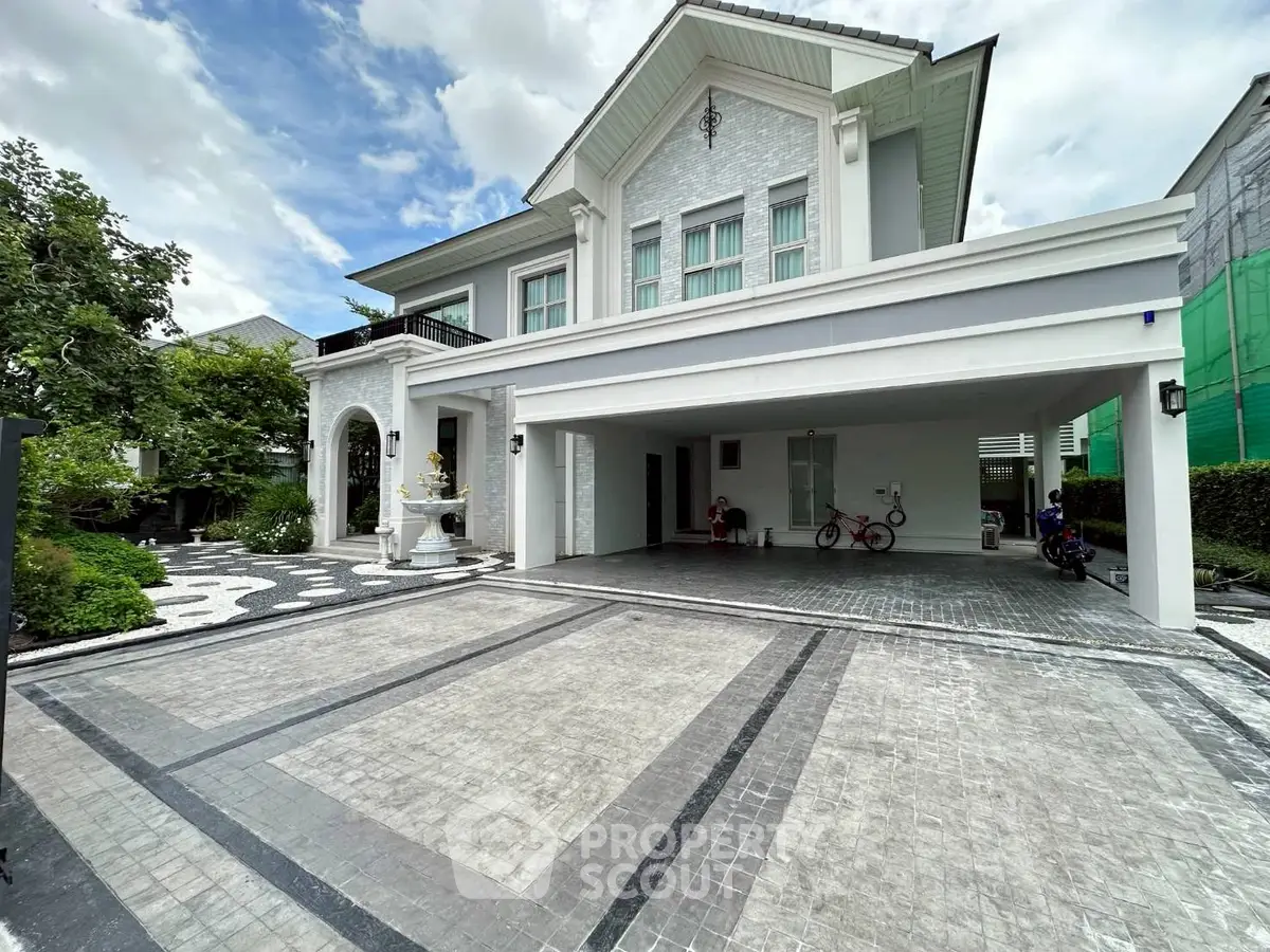 Luxurious modern house with spacious driveway and elegant facade, perfect for upscale living.