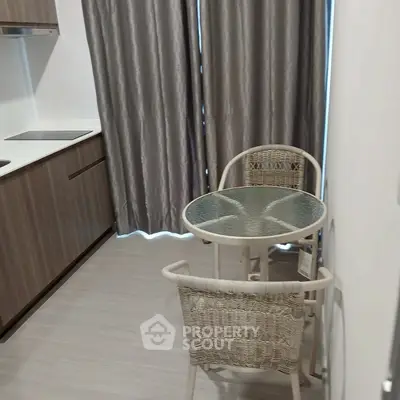 Modern kitchen with sleek cabinetry and cozy dining area