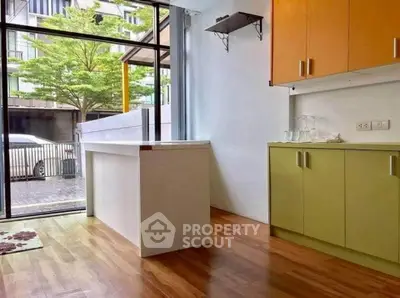 Modern kitchen with colorful cabinets and large window view